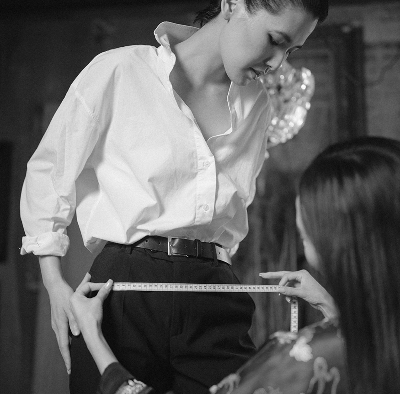 A tailor measuring a client's trousers
