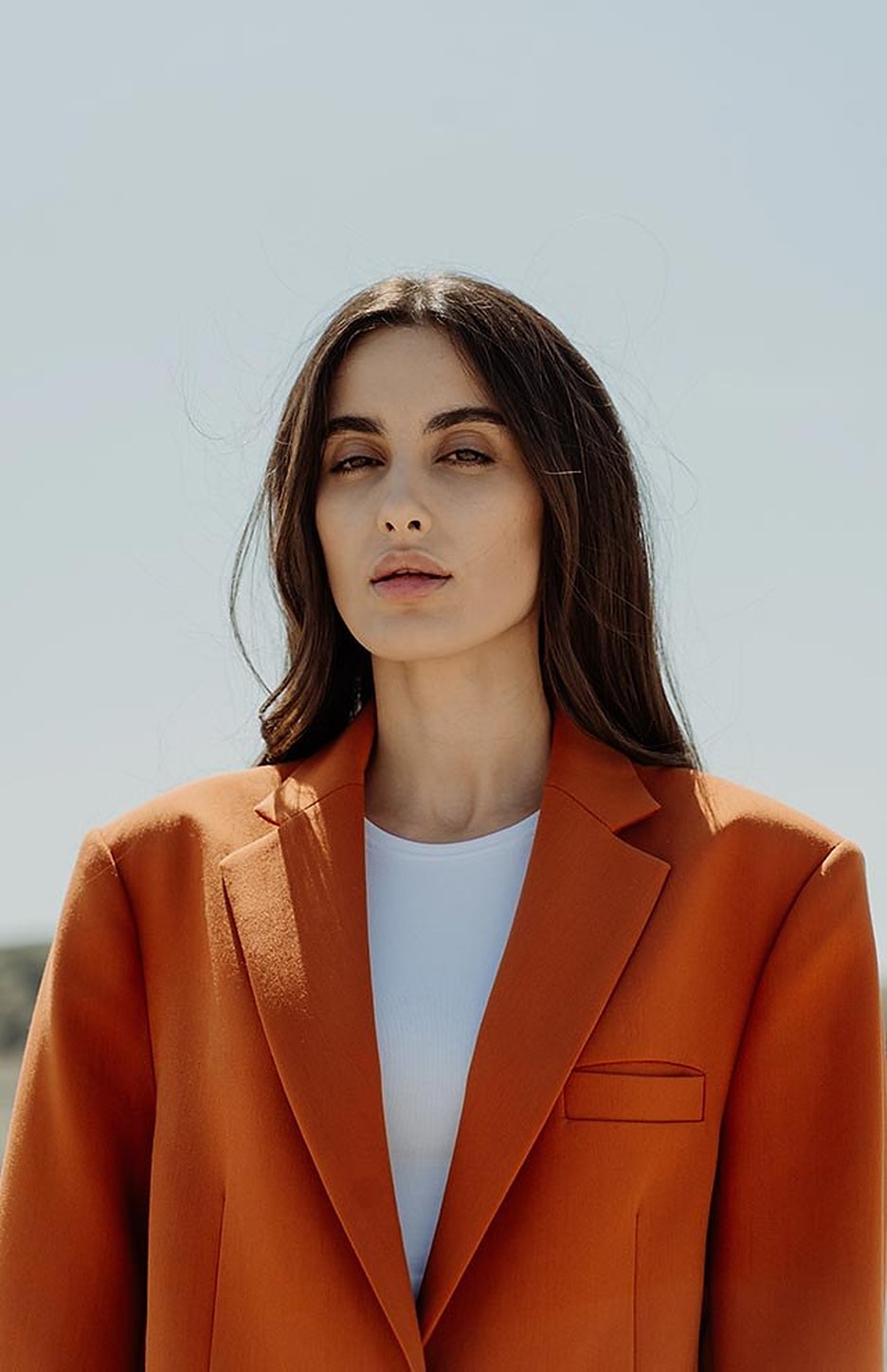 A woman in a rust wool blazer