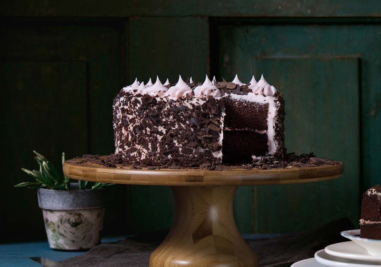 A chocolate layer cake on a stand