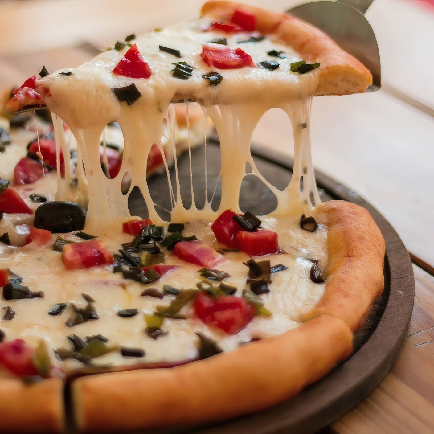 A slice pulled from a pie with a long cheese stretch