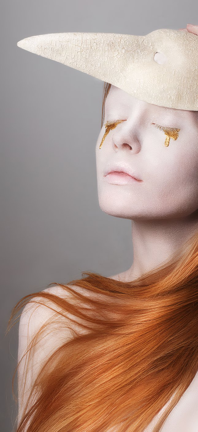 A pale woman with red hair under a white paper mask