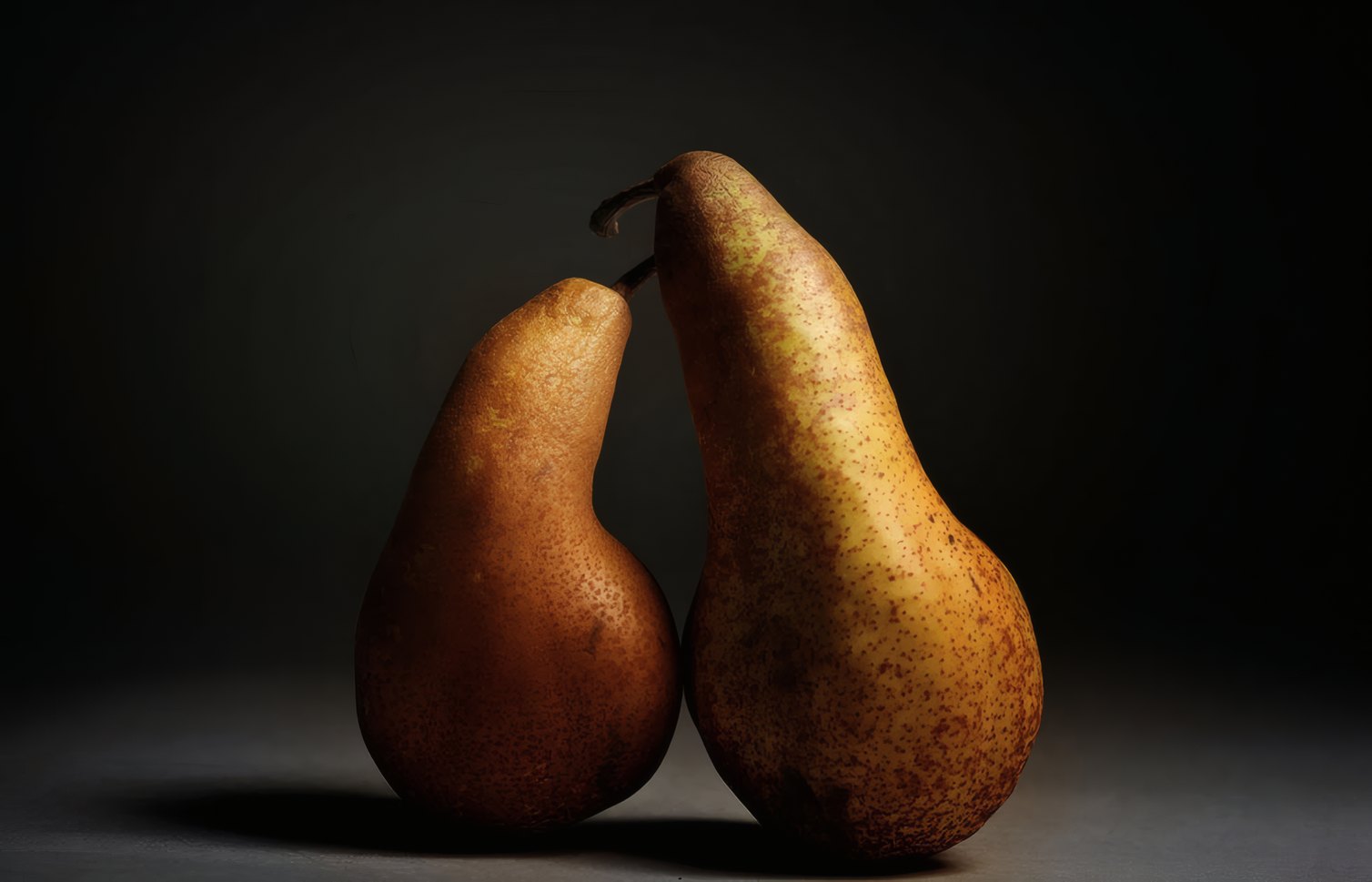 Two pears touching on a black ground
