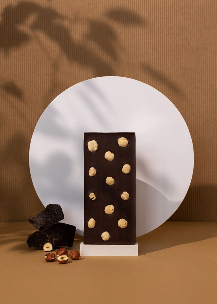 A dark chocolate bar studded with hazelnuts