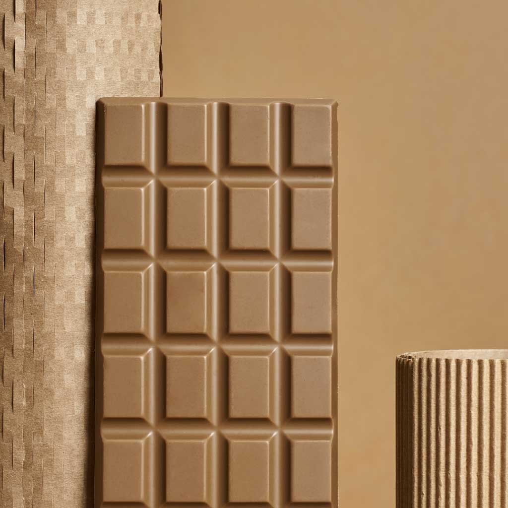 A chocolate tablet standing on a beige linen ground