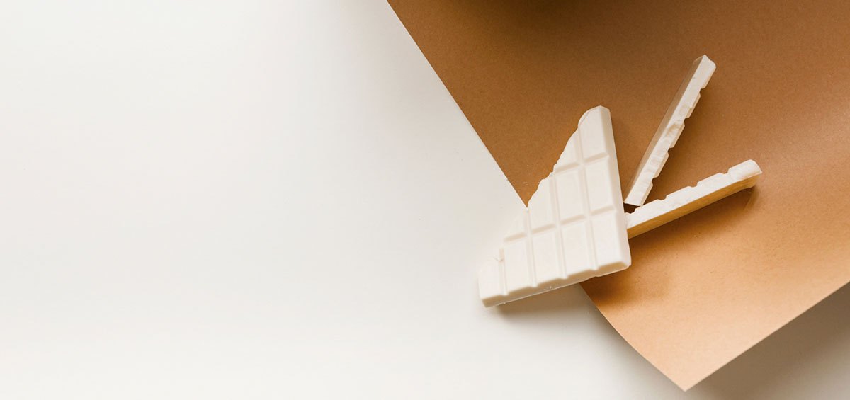 White chocolate shards on a caramel paper fold