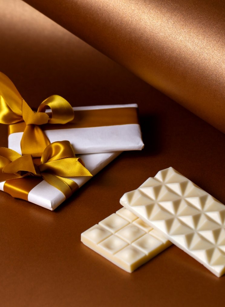 White chocolate bars tied with gold ribbon