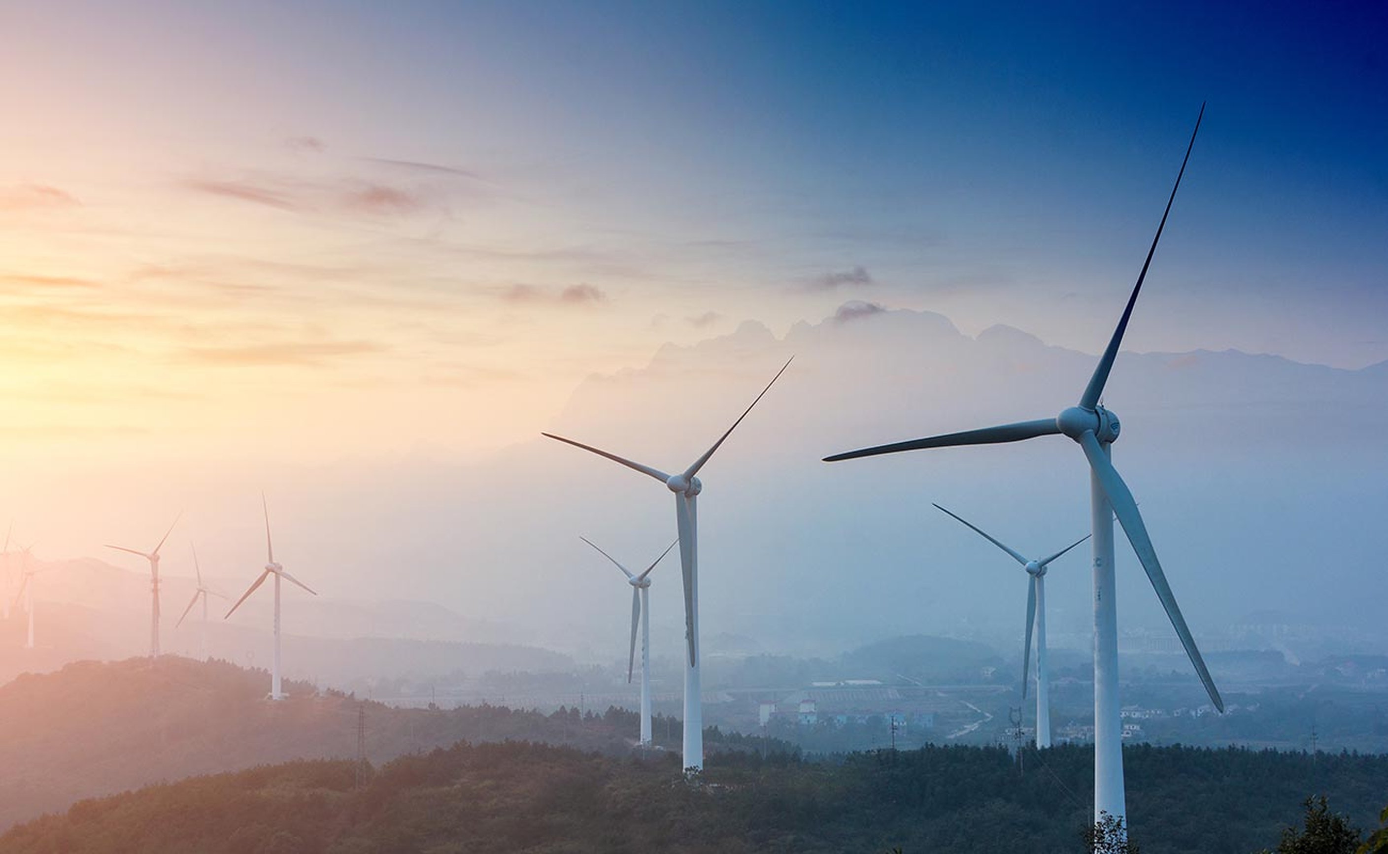 Wind turbines on a ridge at dusk
