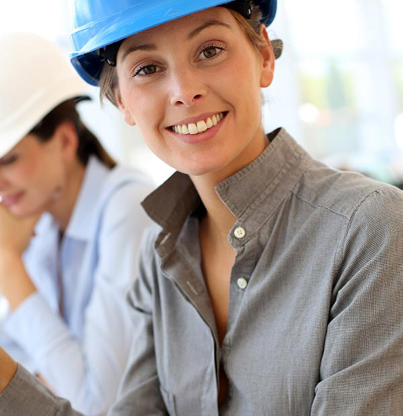 An engineer in a hard hat at a plant