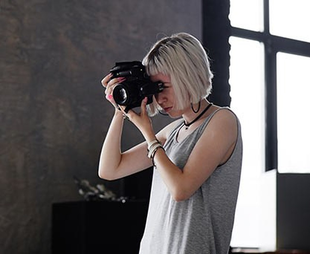 The photographer at work by a tall window