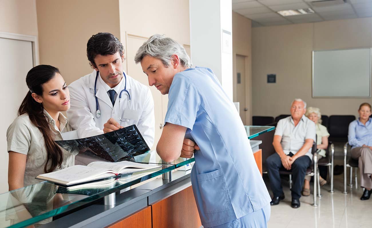 Doctors reviewing an X-ray with a patient