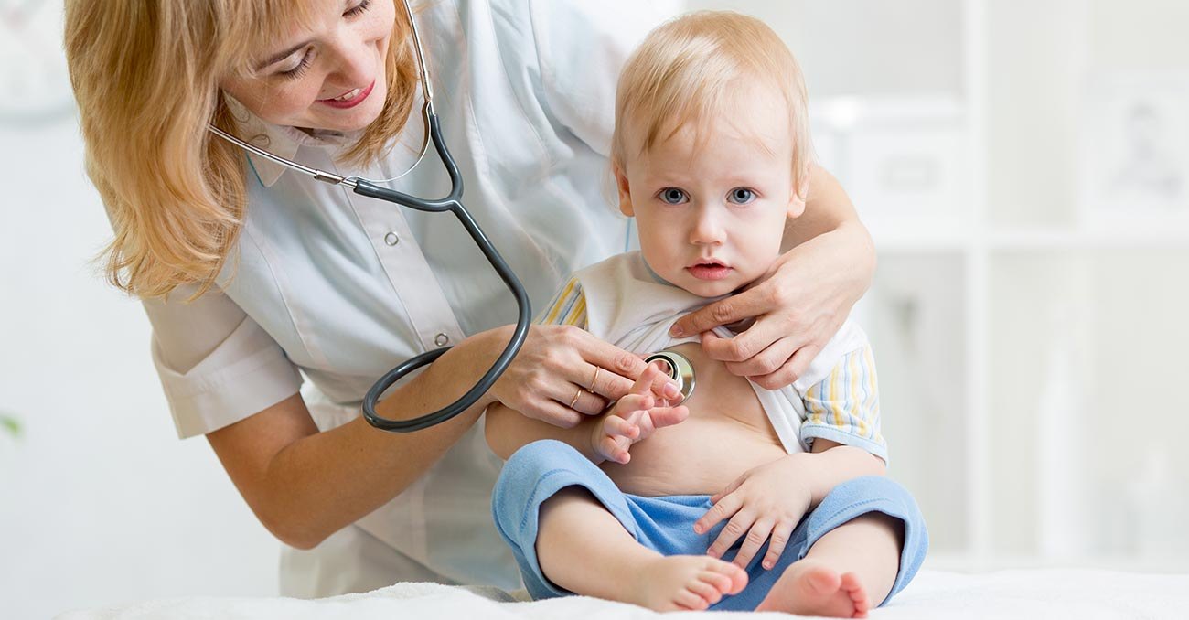 A pediatrician checking a baby