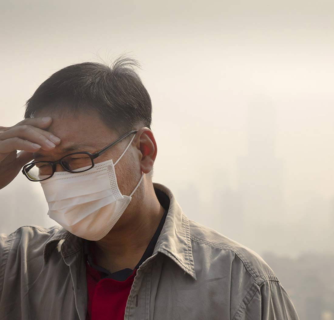 A man in a mask in the smog