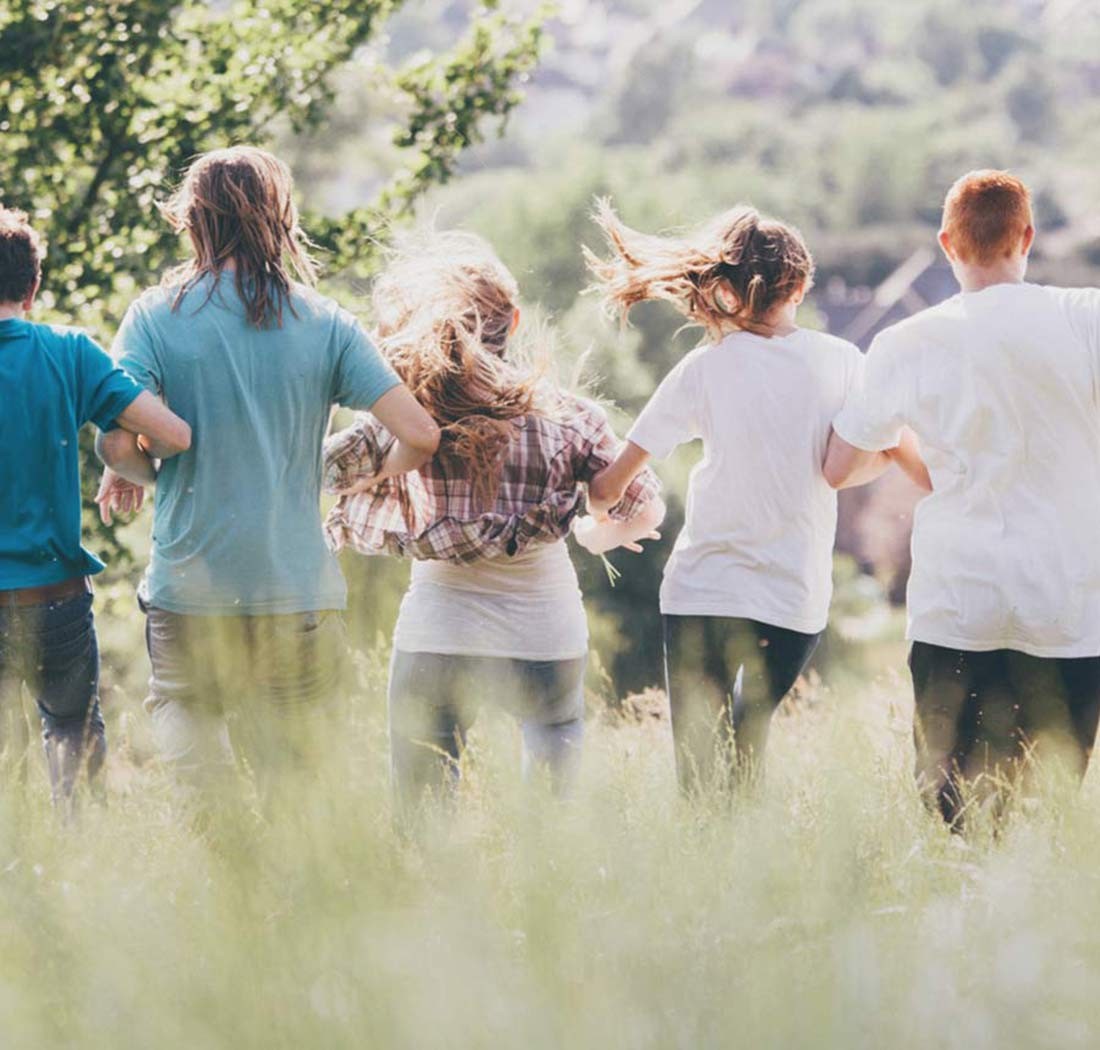 Volunteers running through a meadow
