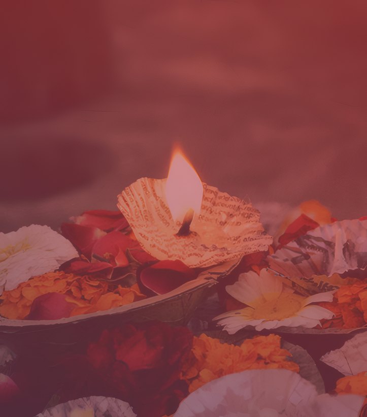 A diya placed among flowers