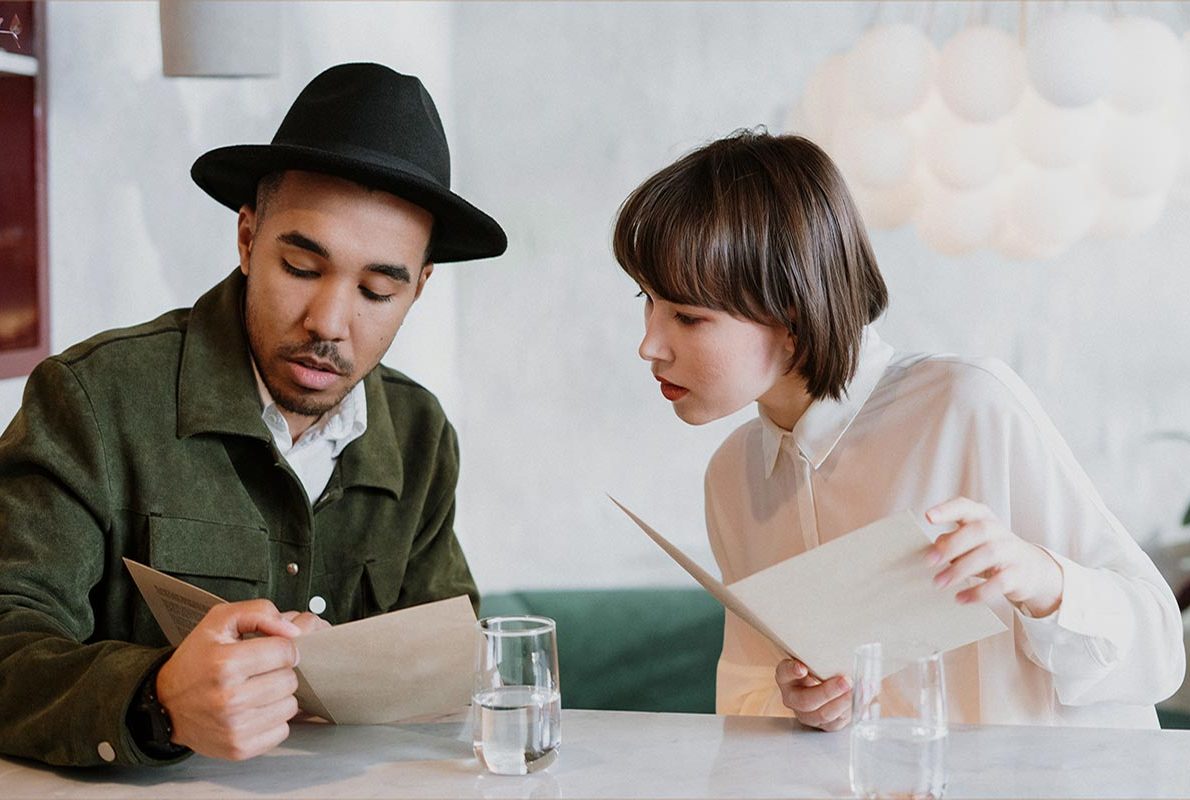 Two guests reading the menu at Lune