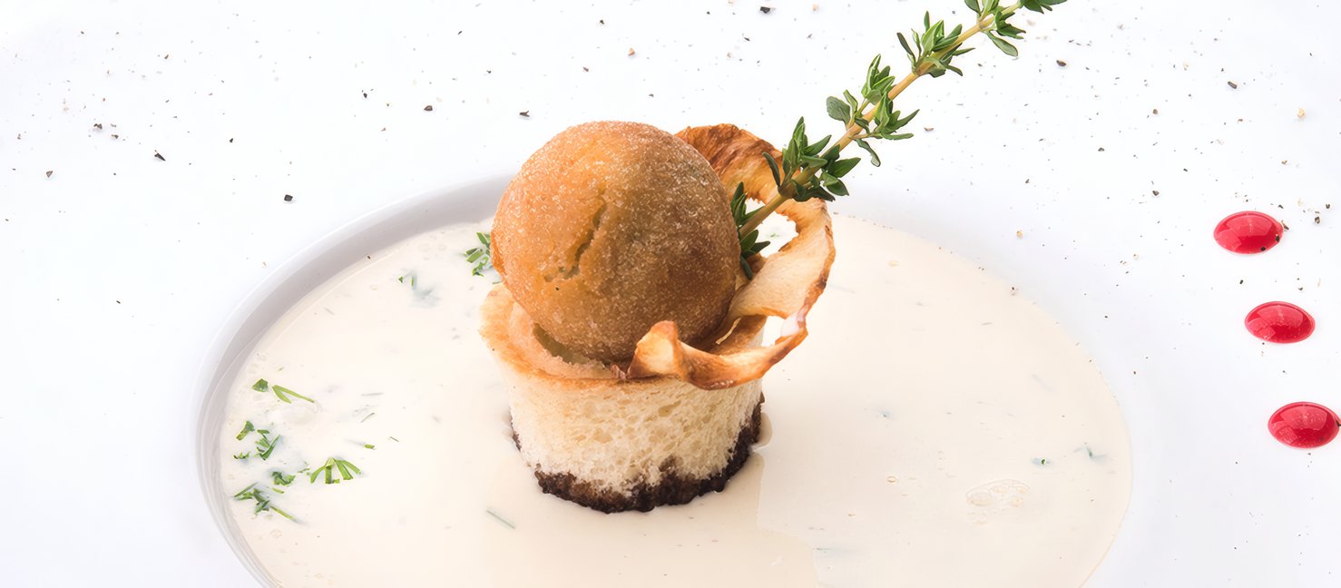 Mushroom arancino on a pool of truffle cream