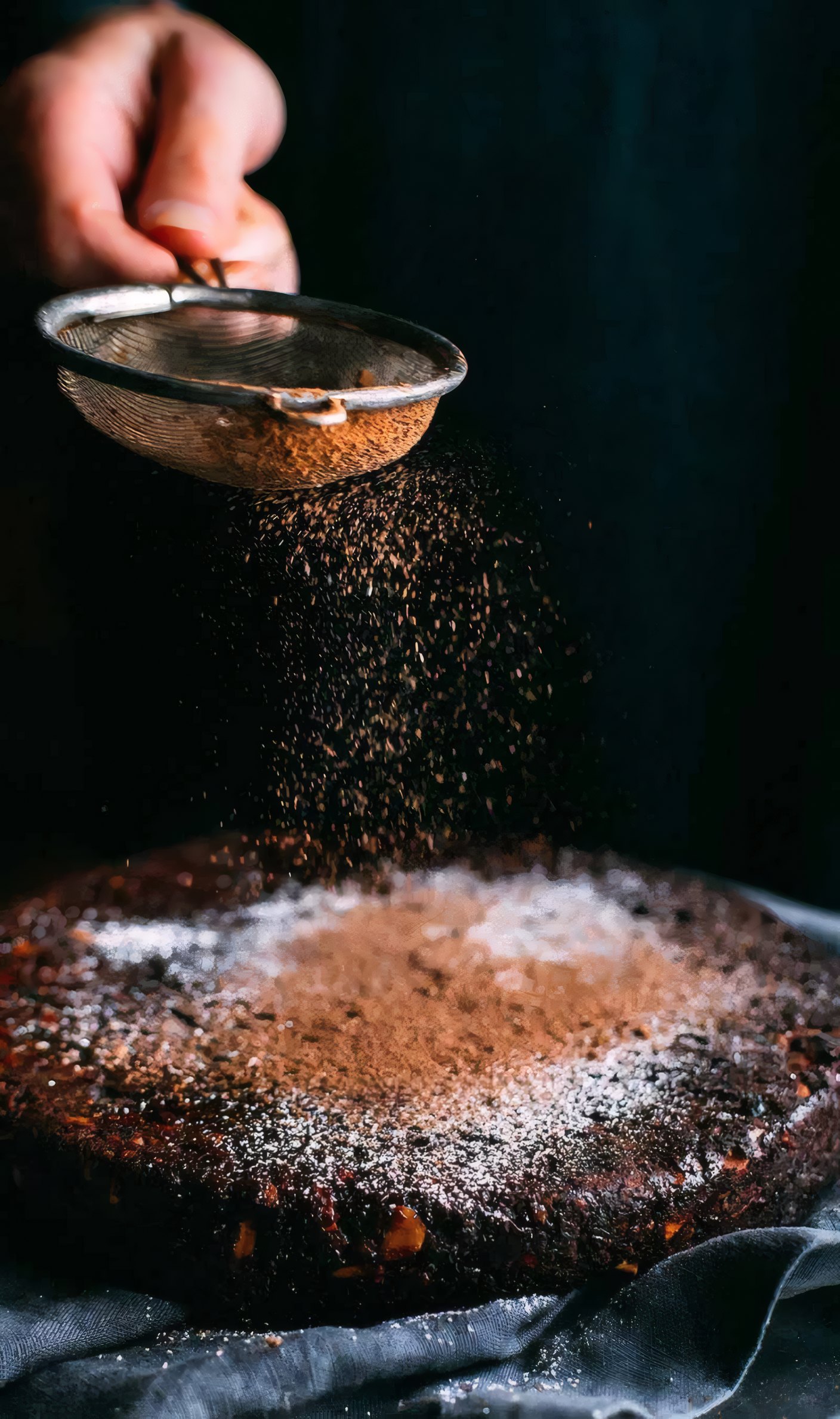 Cocoa dusted over a chocolate tart