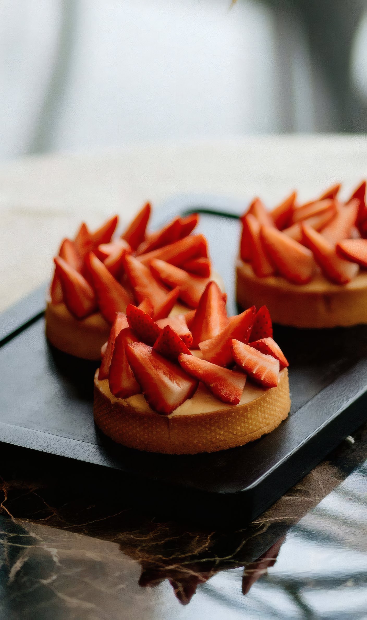 Strawberry tartlets on a slate