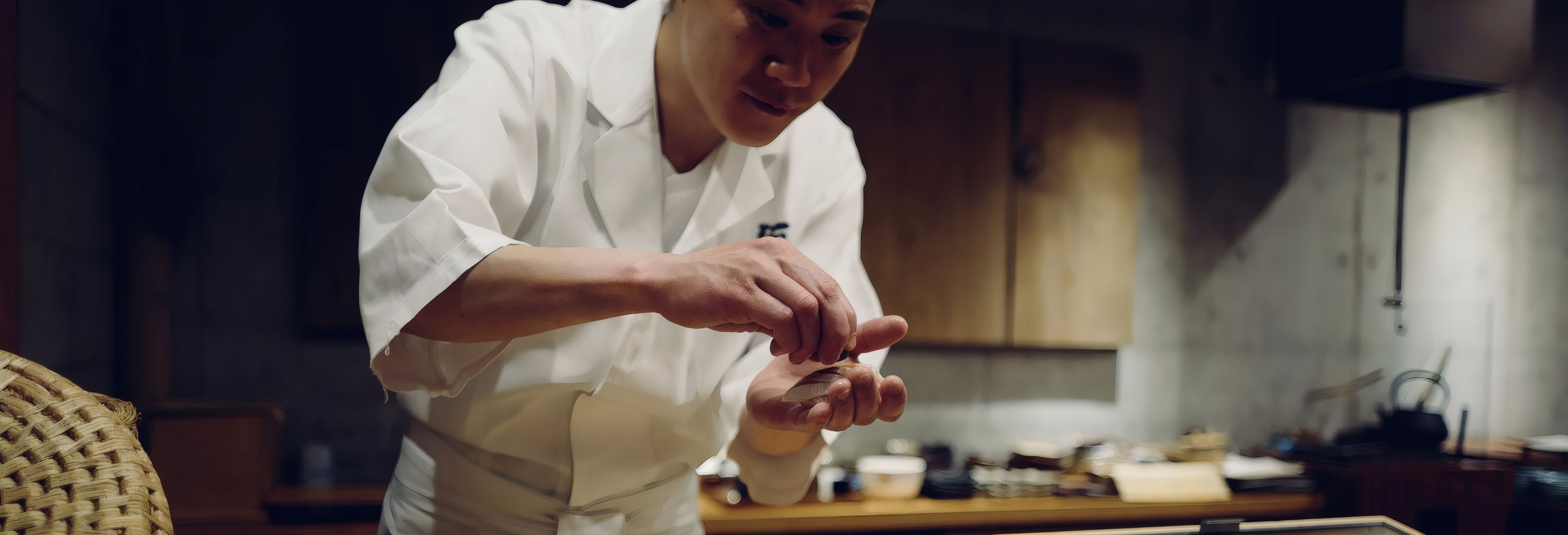 A chef plating at the pass