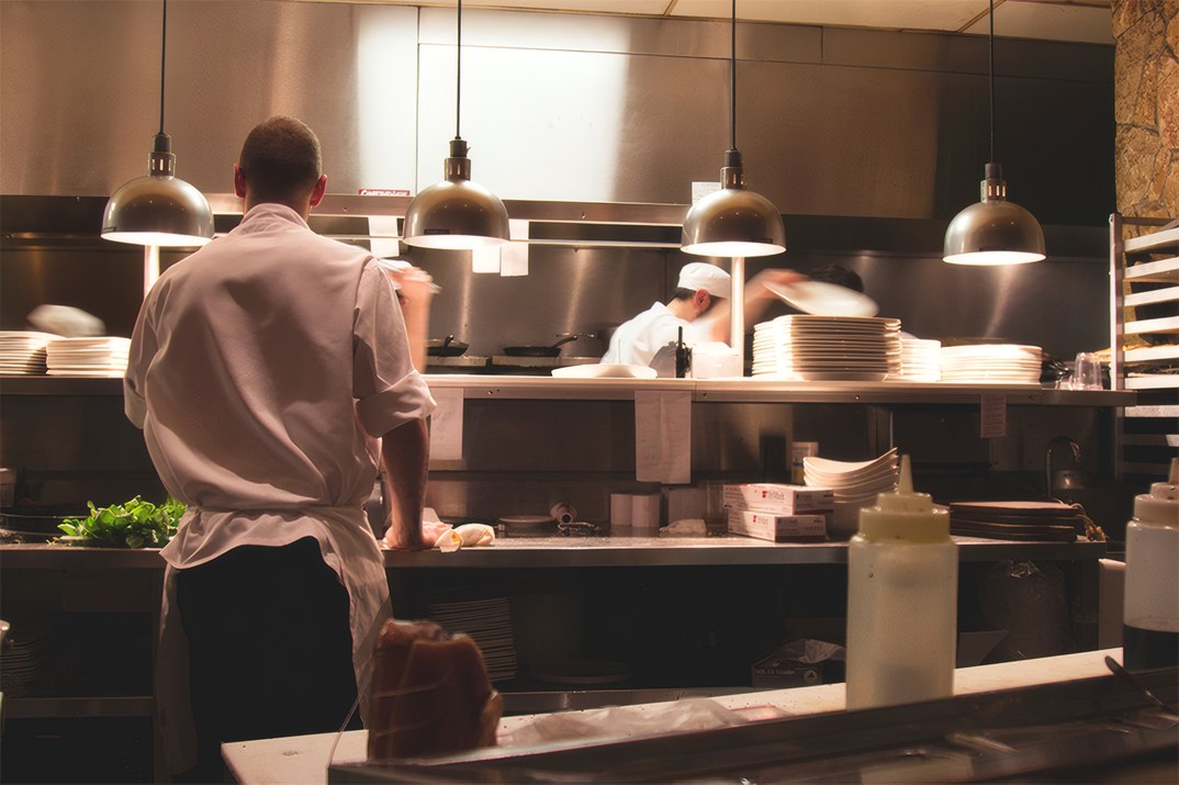 A chef at the pass of the Cookora kitchen