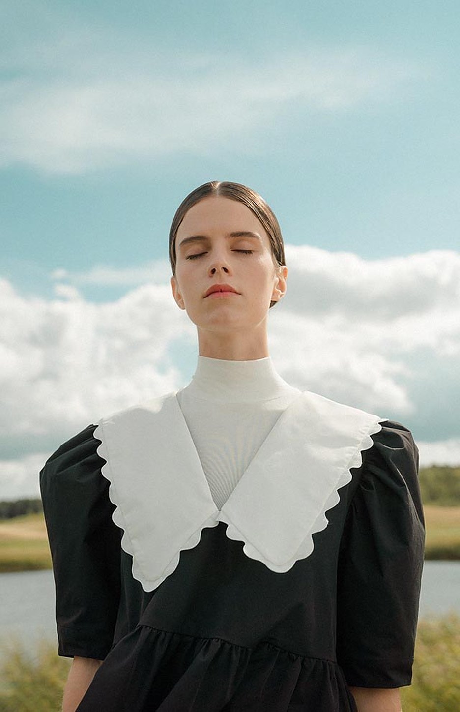 A black dress with a scalloped ivory collar