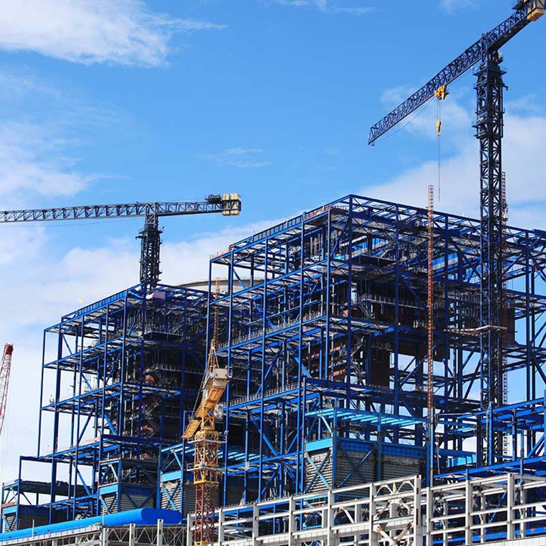 A steel frame between tower cranes