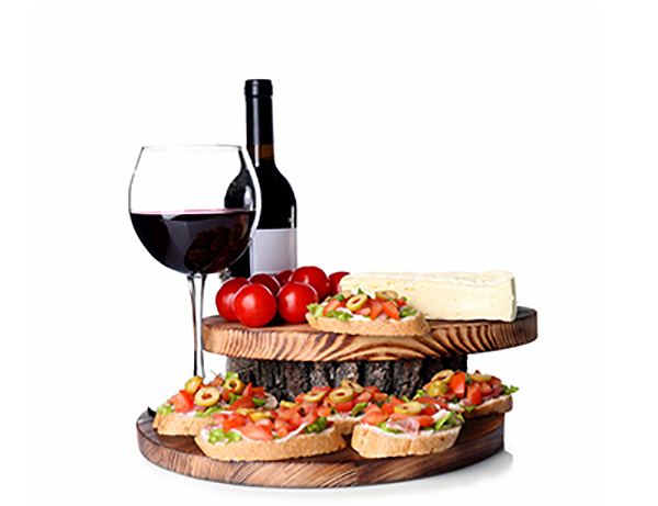 A glass of red beside a board of bruschetta