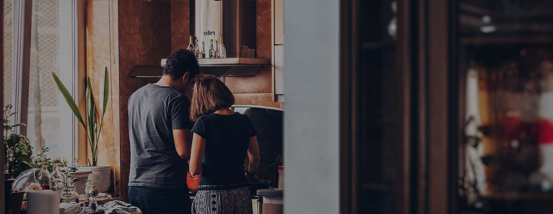 A couple unpacking groceries in the kitchen