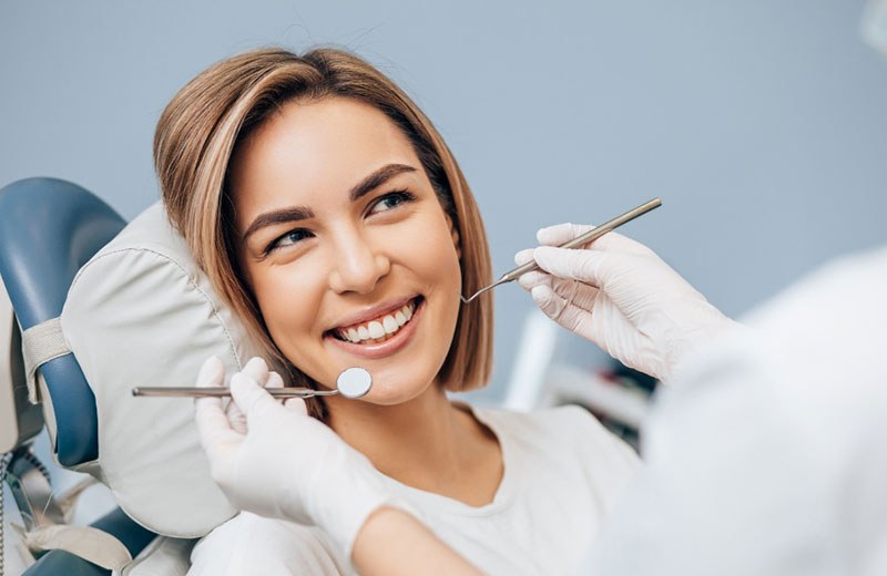 A patient smiling in the dental chair