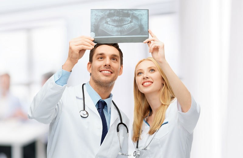 Two dentists reading an x-ray