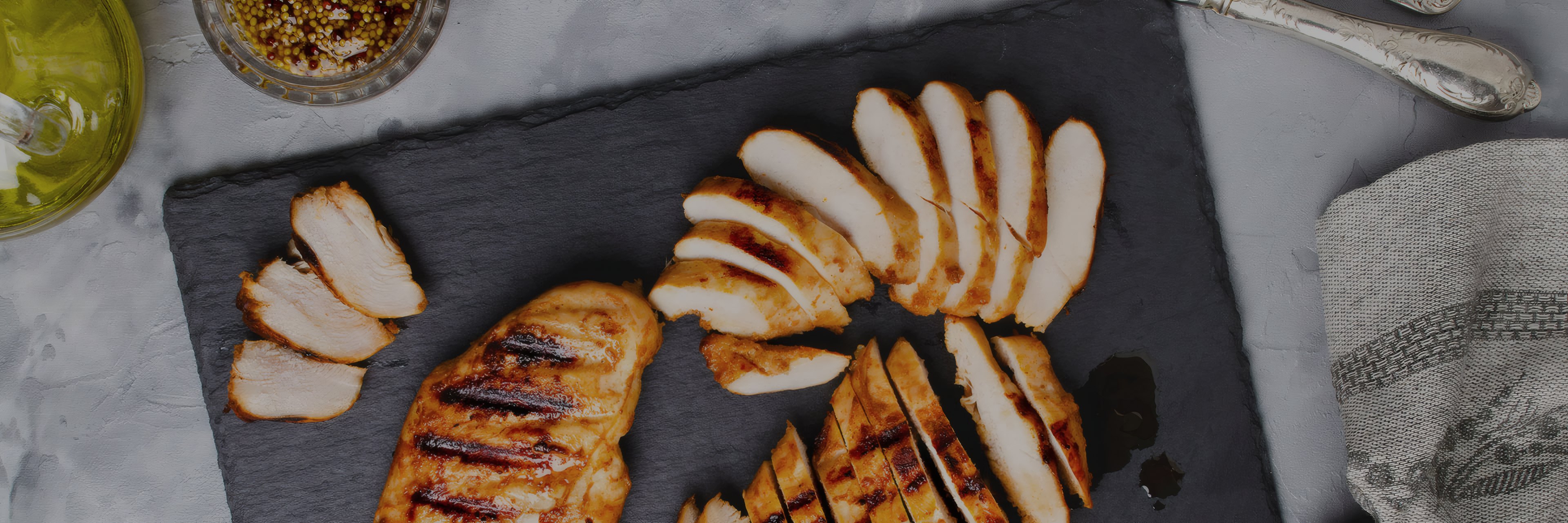 Grilled chicken sliced on a slate board