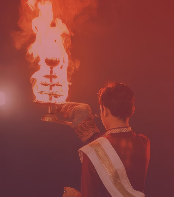 Priest raising the aarti flame