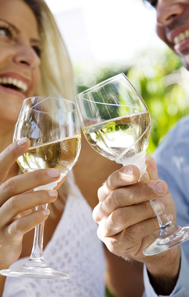 Two glasses of white wine raised