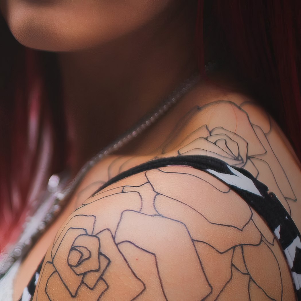 A fresh fine-line rose, the day it was tattooed