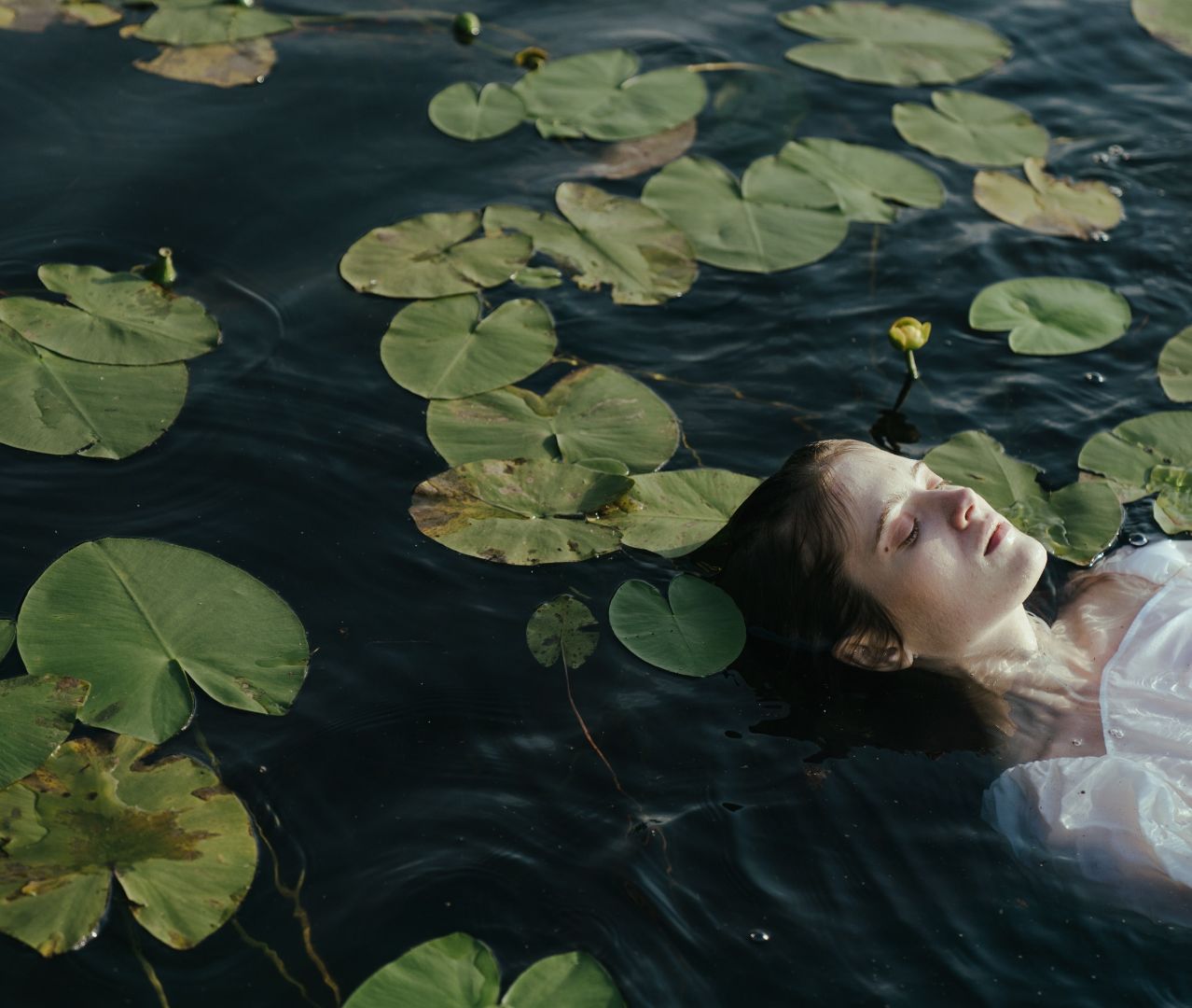 A singer floating among lily pads, from Undertow