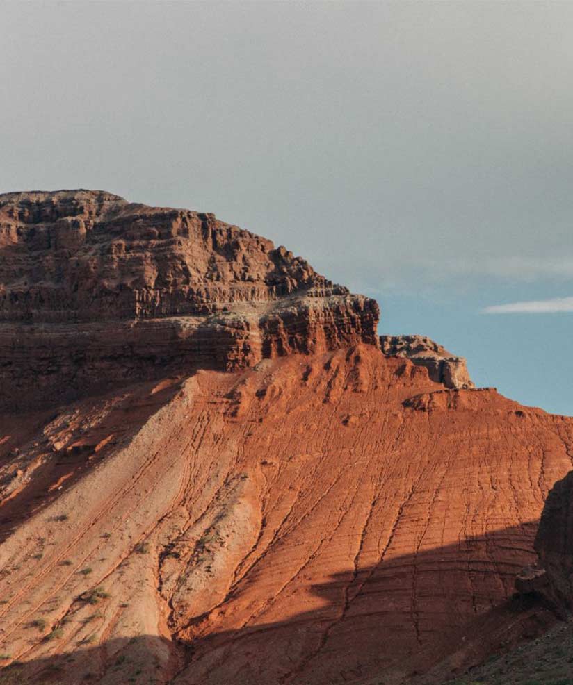 A frame from The Long Dry: a red mesa under a pale sky