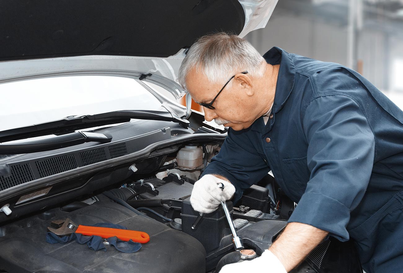 A mechanic servicing an engine