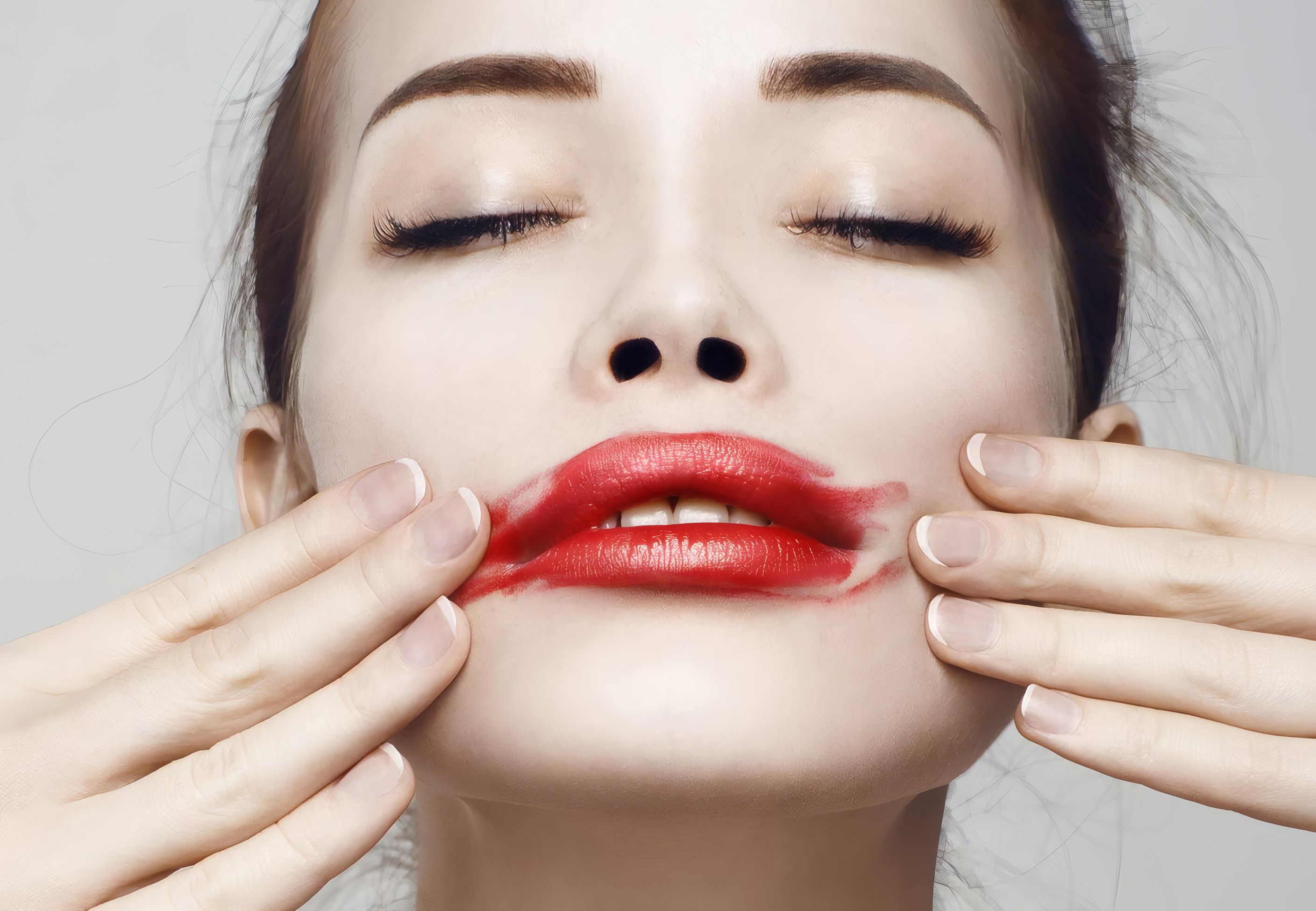 Red lipstick smudged by two hands for Rouge Celeste