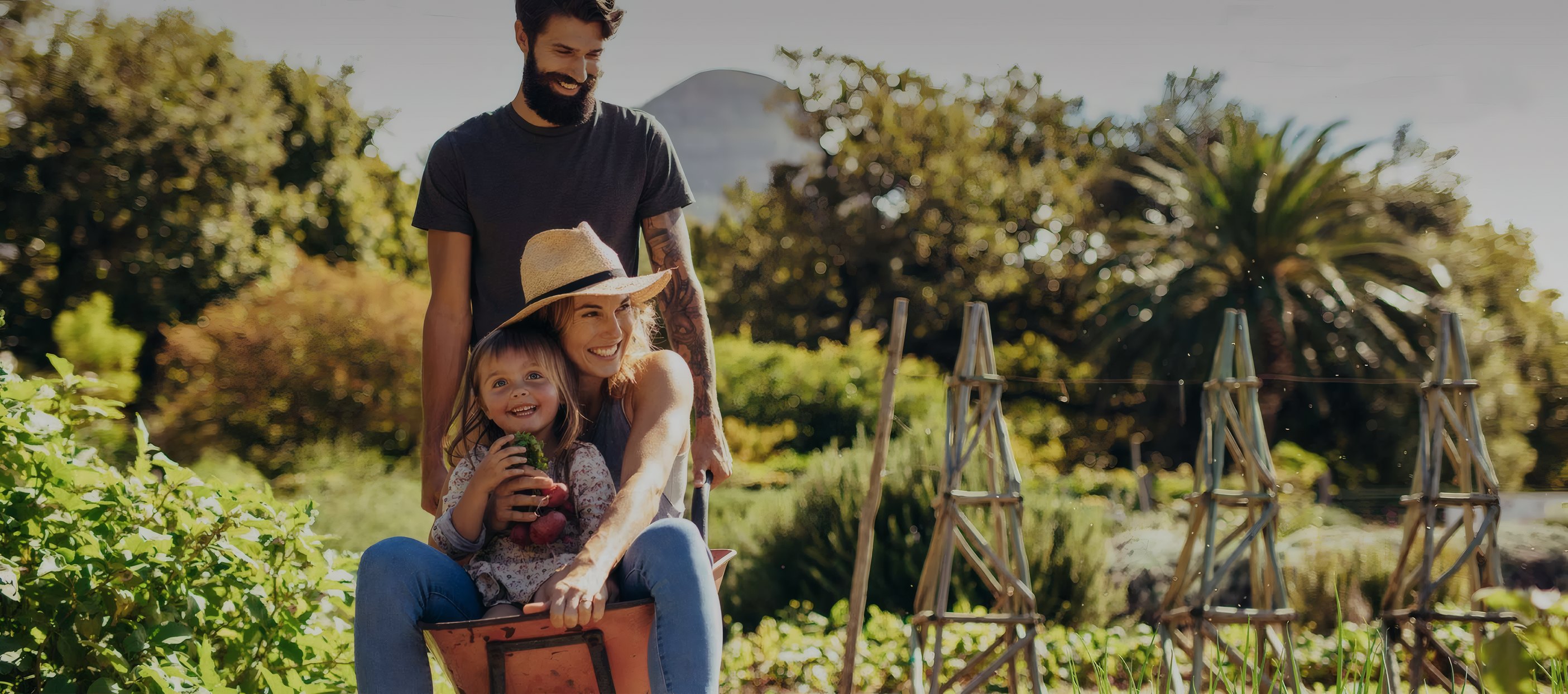 A family filling a wheelbarrow at the farm