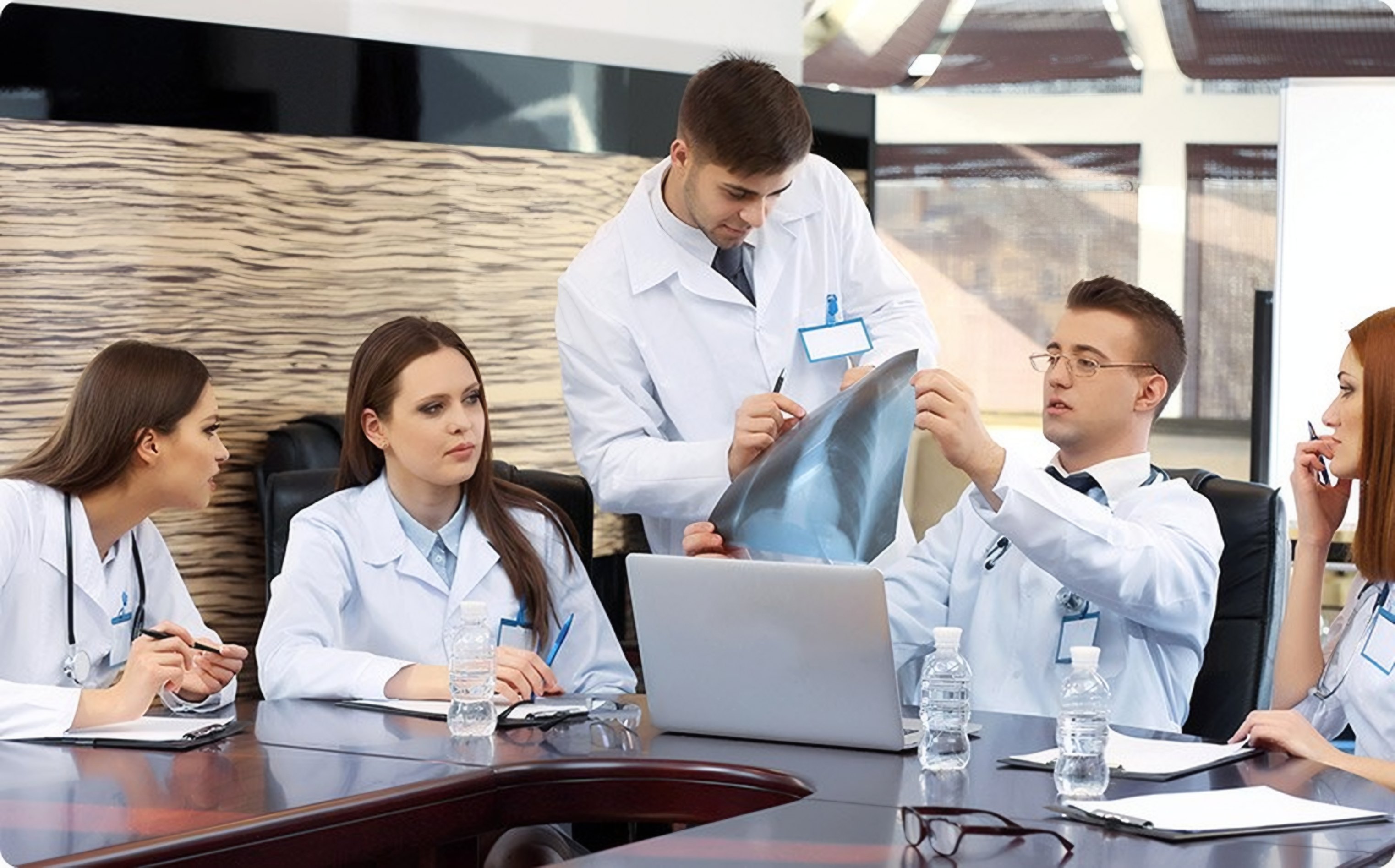 Doctors talk through a case at a table
