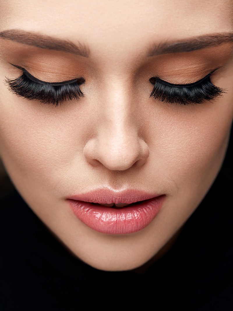 A client with long lashes, eyes closed