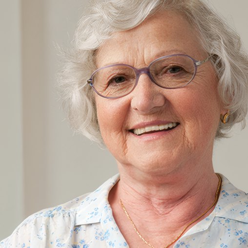 A smiling resident with glasses