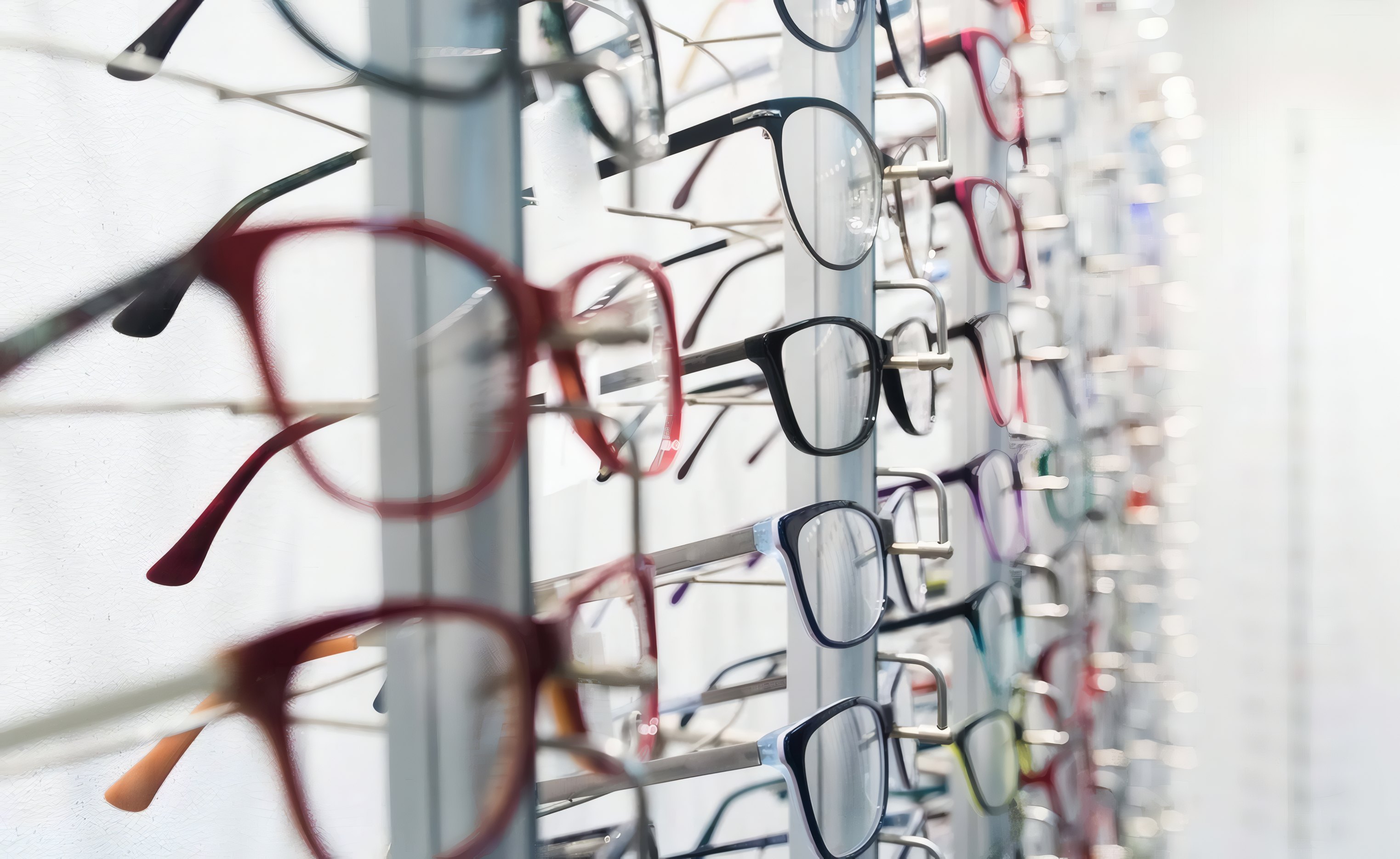 A wall of glasses frames in the optical shop