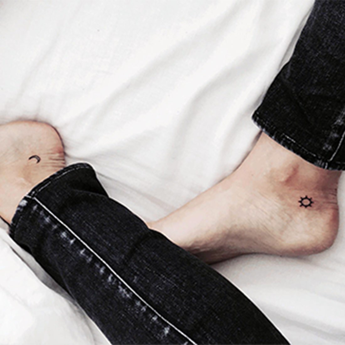 A tiny sun and moon on two ankles