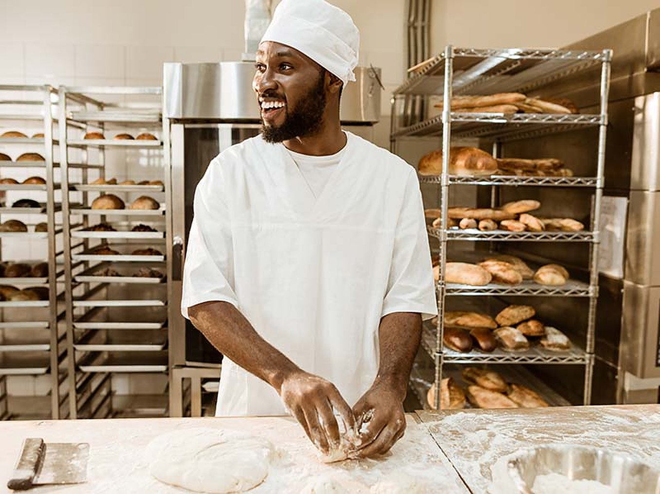 A baker kneading dough in the bakehouse