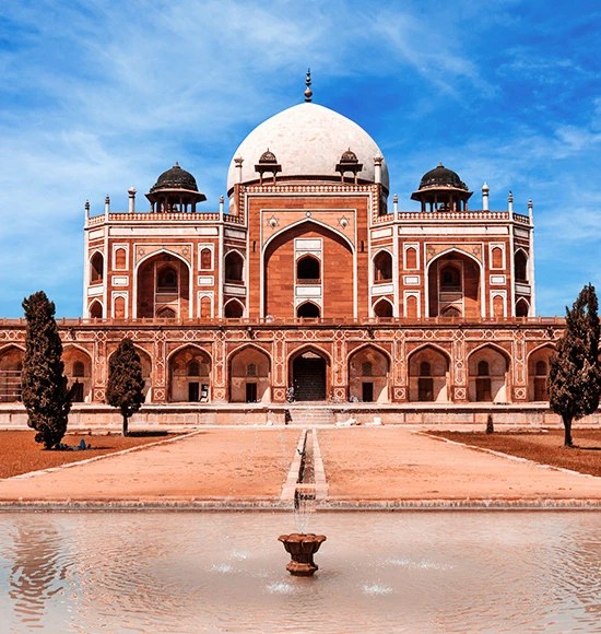 A domed tomb reflected in a long garden pool