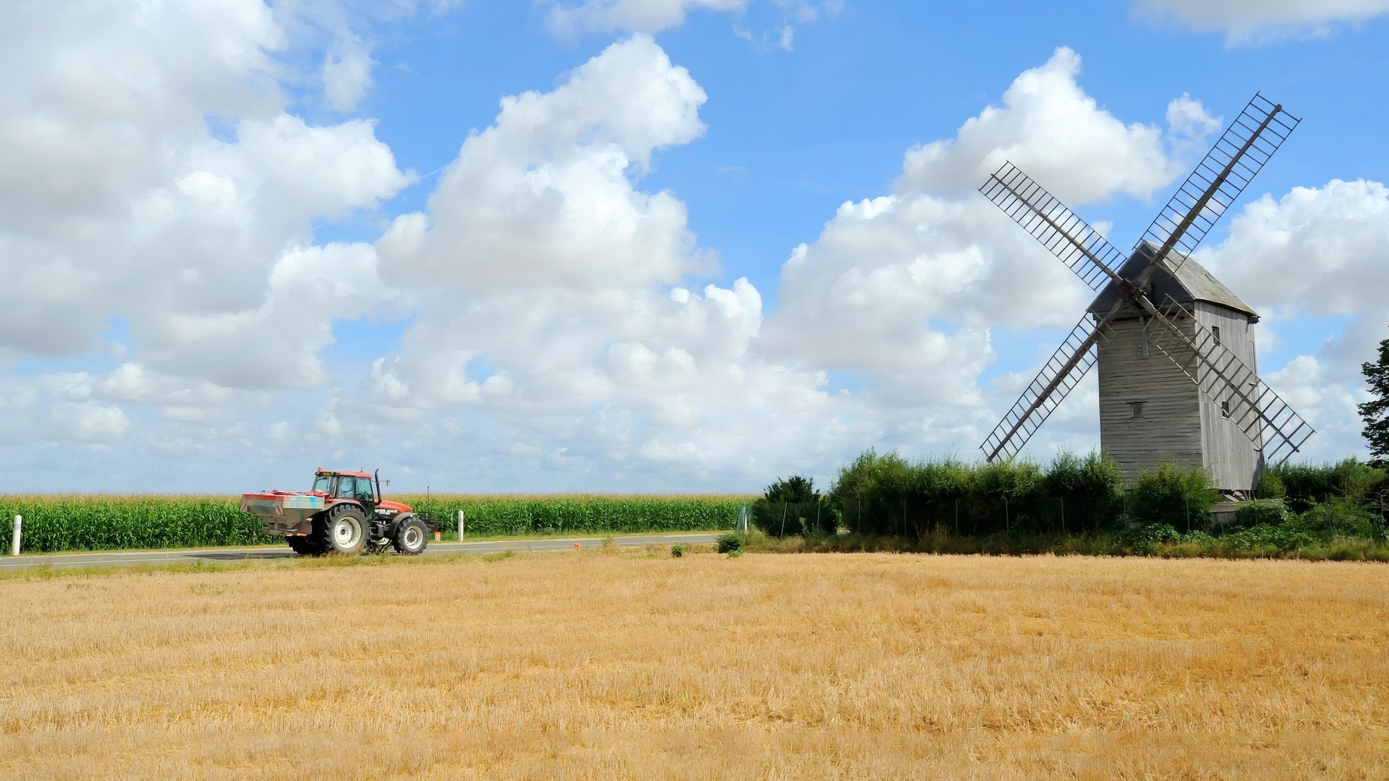 A windmill over a harvested field