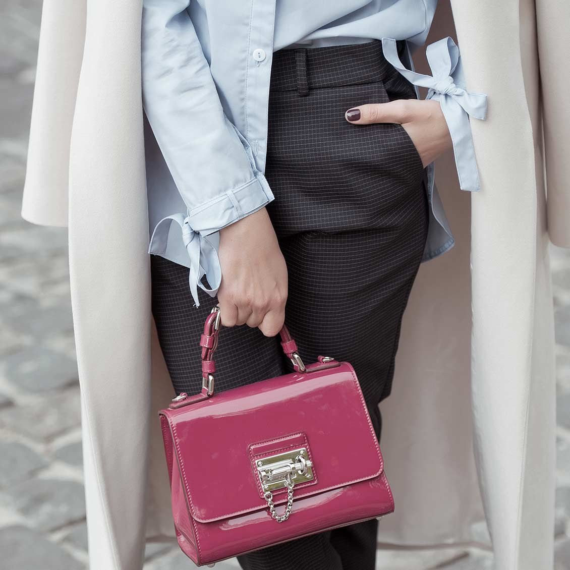 Pale blue cuffs and a raspberry top-handle bag