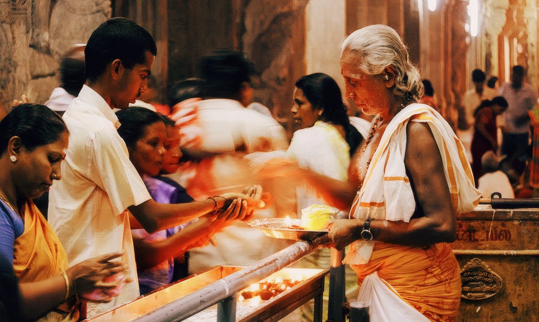 Devotees lighting lamps at the temple