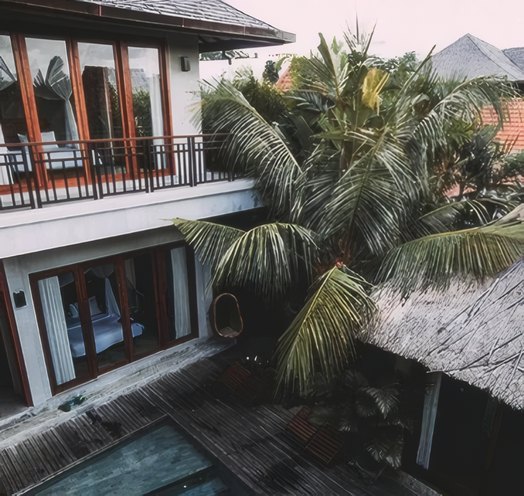 A villa balcony framed by palms